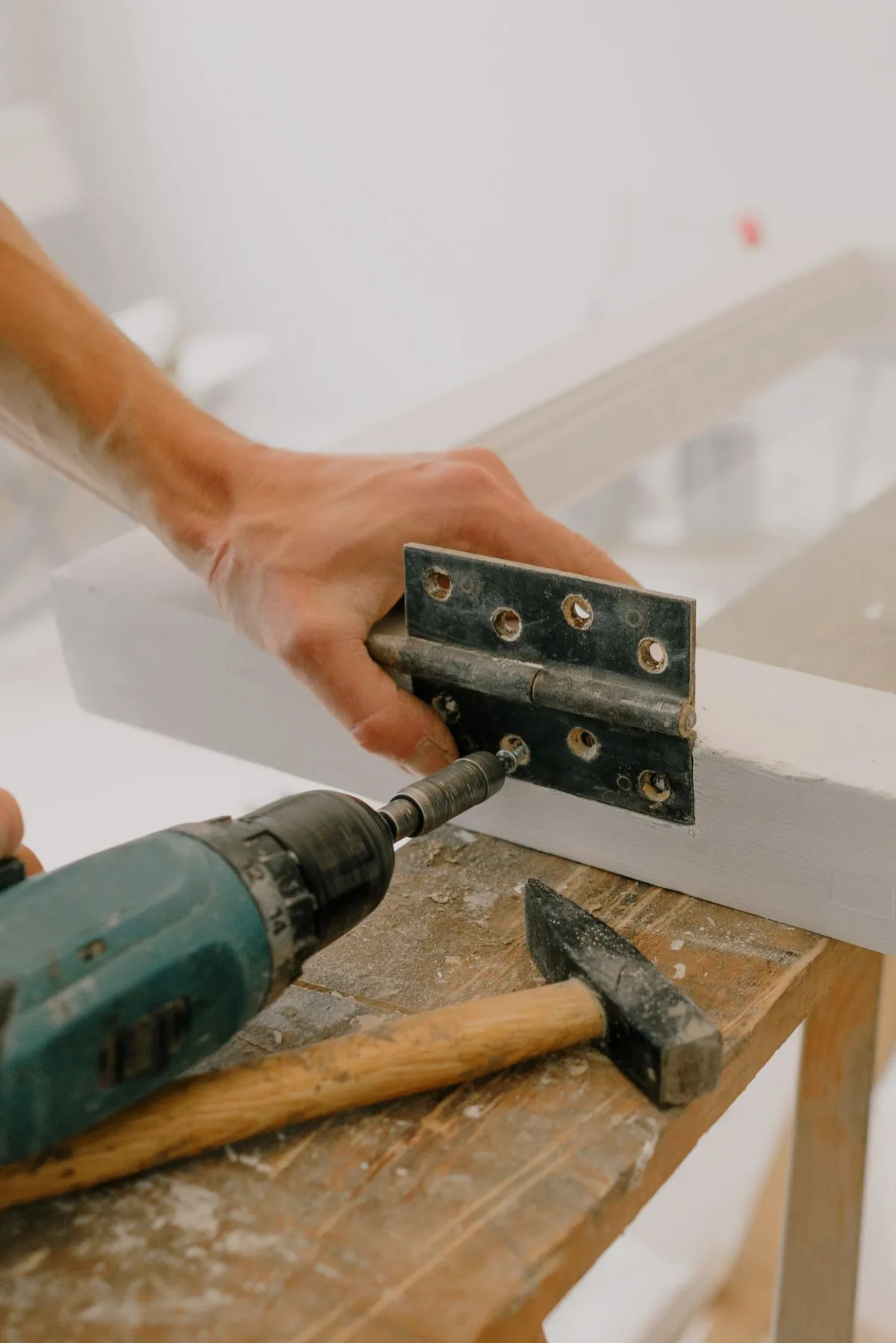 Glass panel and hardware laid out on a workbench before cutting and fitting