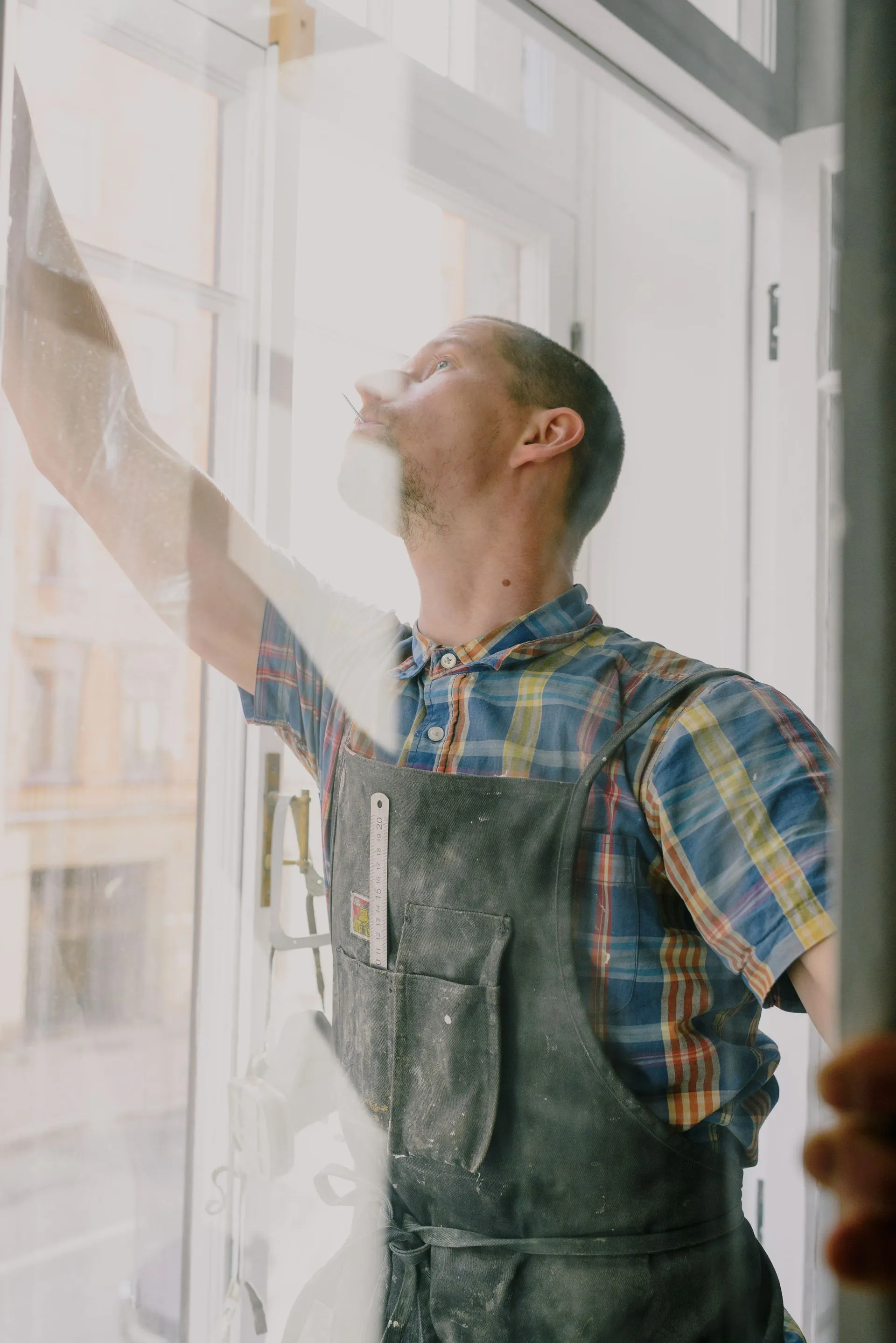 Window technician fitting a new window unit into a residential frame in Mesa